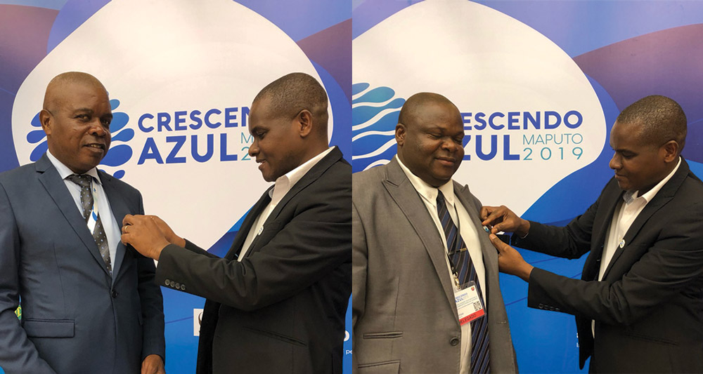 Mozambique local leaders taking a pledge and receiving a pin